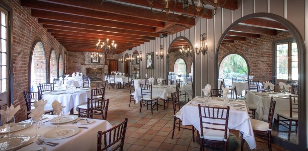Several tables set up inside Broussard’s Restaurant & Courtyard, representing a wedding venue listed by The Event Glossary in New Orleans, LA