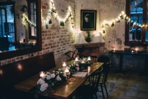 A table set with a floral centerpiece representing historic wedding venues in new orleans, la